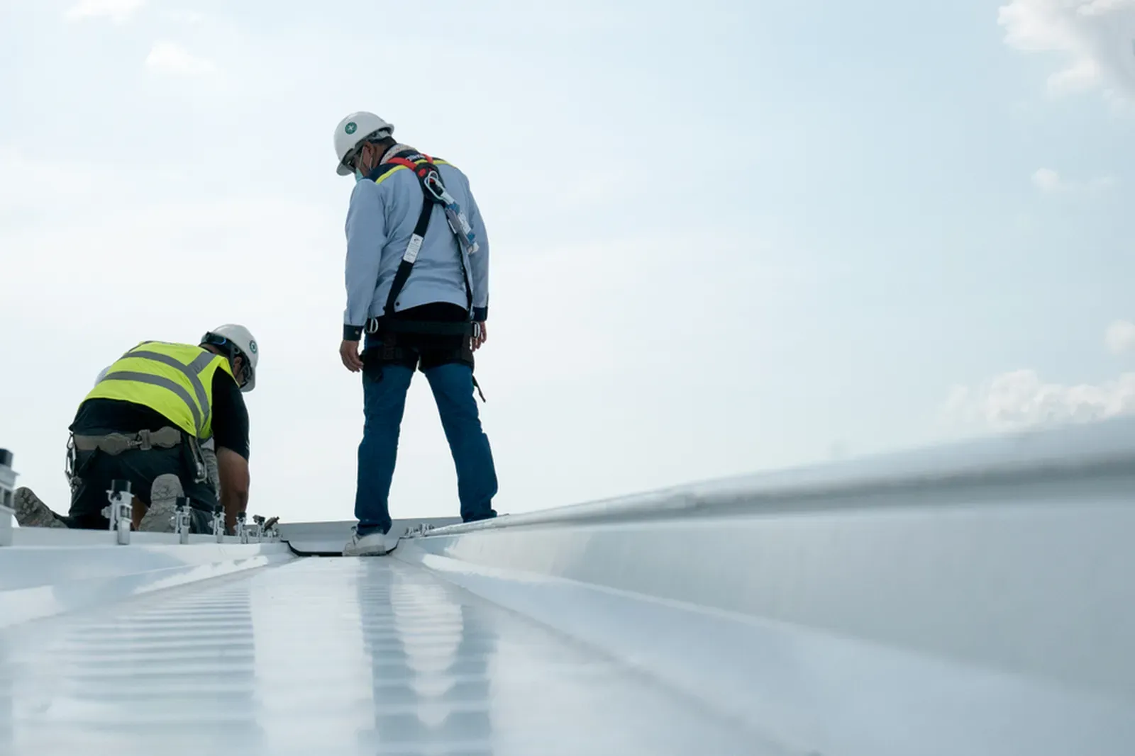 "Installation of EPDM roofing on a commercial building, showcasing a roof replacement process." | Omega Exteriors